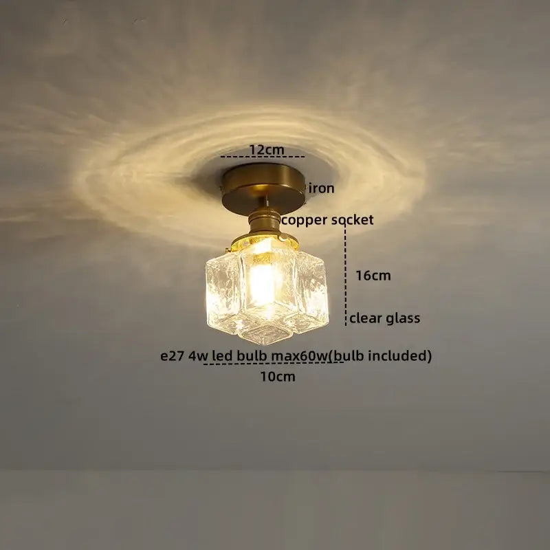 A vintage-style ceiling light with brass iron base copper socket and clear faceted glass shade for elegant lighting