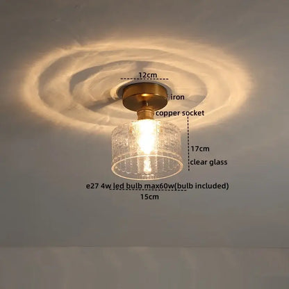 A vintage-style ceiling light with brass iron base copper socket and clear textured glass shade for modern led ceiling light