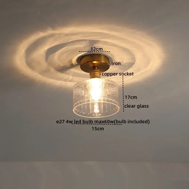A vintage-style ceiling light with brass iron base copper socket and clear textured glass shade for modern led ceiling light