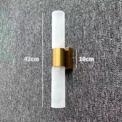 Modern led wall lamp featuring frosted glass shades with a brushed brass accent band for bedroom use