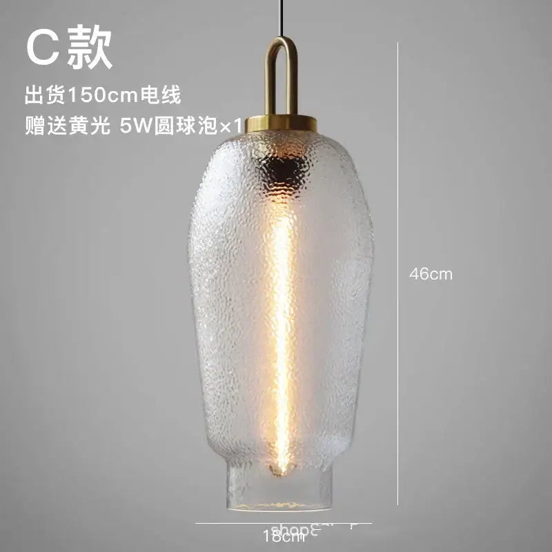 Modern frosted glass pendant light with textured clear glass and brass-finished metal top for kitchen use