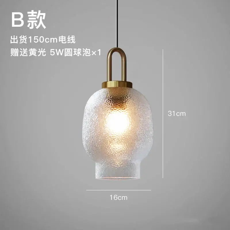 Modern frosted glass pendant lights with textured warm glass and brass metal fixture for kitchen lighting use