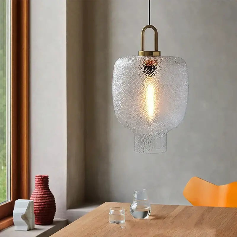 Modern frosted glass pendant light with brass-finished metal fixture ideal for kitchen glass pendant lights