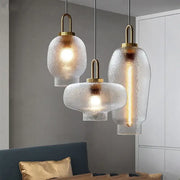 Three modern glass pendant lights with frosted glass shades and brass finish for kitchen LED hanging lamps