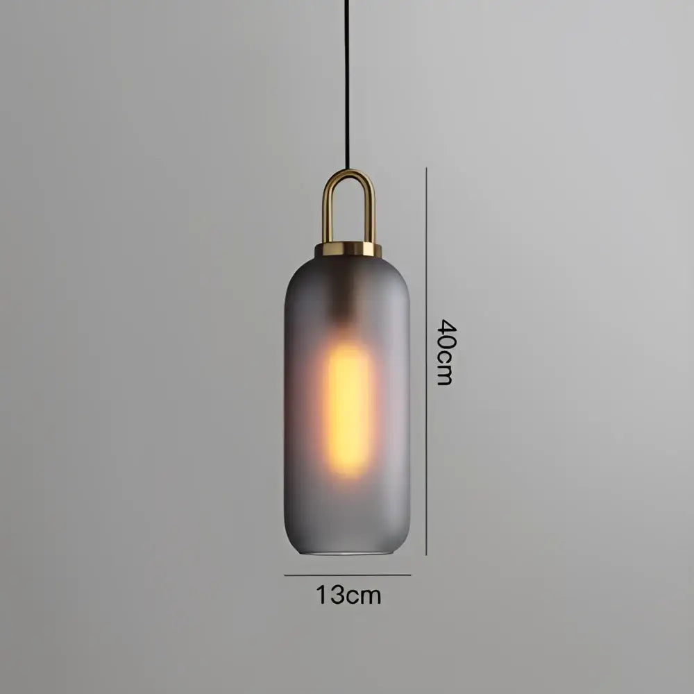 Modern frosted gray glass ball pendant light with brass hardware and illuminated edison bulb for dining room decorbites glass ball pendant