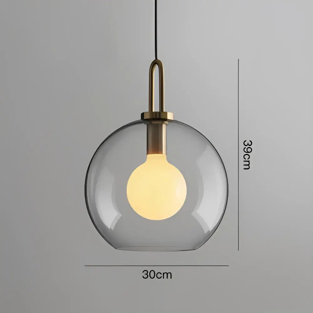 Modern frosted gray glass ball pendant light with brass fixture and warm bulb for dining room decorbites glass ball pendant