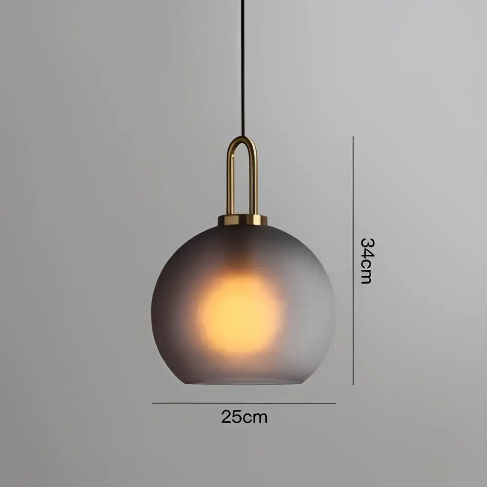 Modern frosted gray glass ball pendant light with brass hardware and warm glow for dining room decorbites glass ball pendant