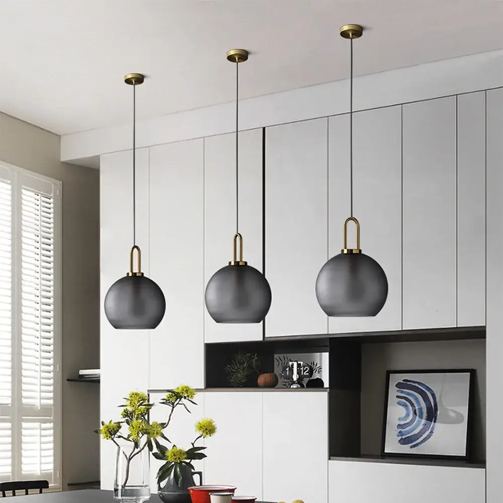 Three modern pendant lights with matte black frosted glass ball shades and brass fixtures for dining room decorbites glass ball pendant