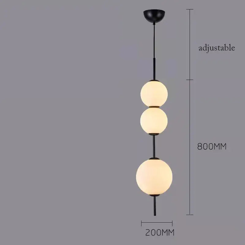 Black metal pendant lamp with three frosted white glass balls designed for modern dining room lighting