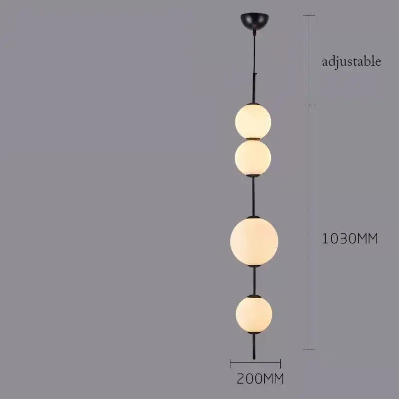 Black metal pendant lamp with four frosted white glass balls ideal for modern dining room lighting