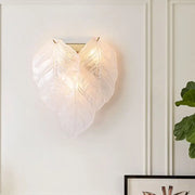 Modern frosted white glass leaf wall sconce light with translucent overlapping leaves and visible veining design