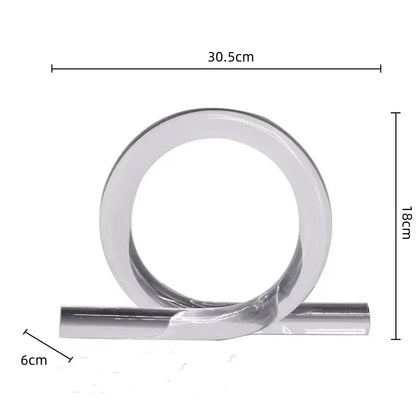 A sleek minimalist metallic ring with polished chrome finish and twisted design for modern geometric acrylic rope knot decor