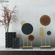 Modern geometric alloy marble base statue with circular metal discs in matte black bronze and gold for home decor by decorbites