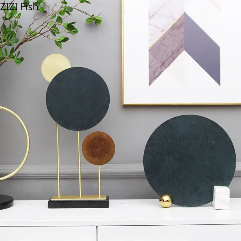 Modern geometric alloy sculpture with black marble base in matte black bronze and gold tones for home decor by decorbites