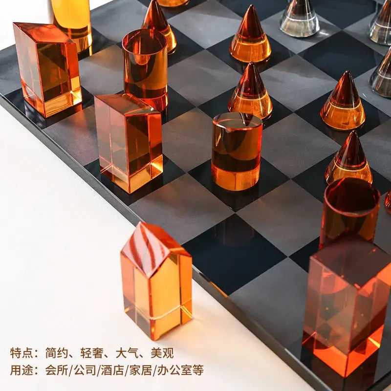 Orange translucent acrylic chess set with modern geometric design on black and gray board for home decor