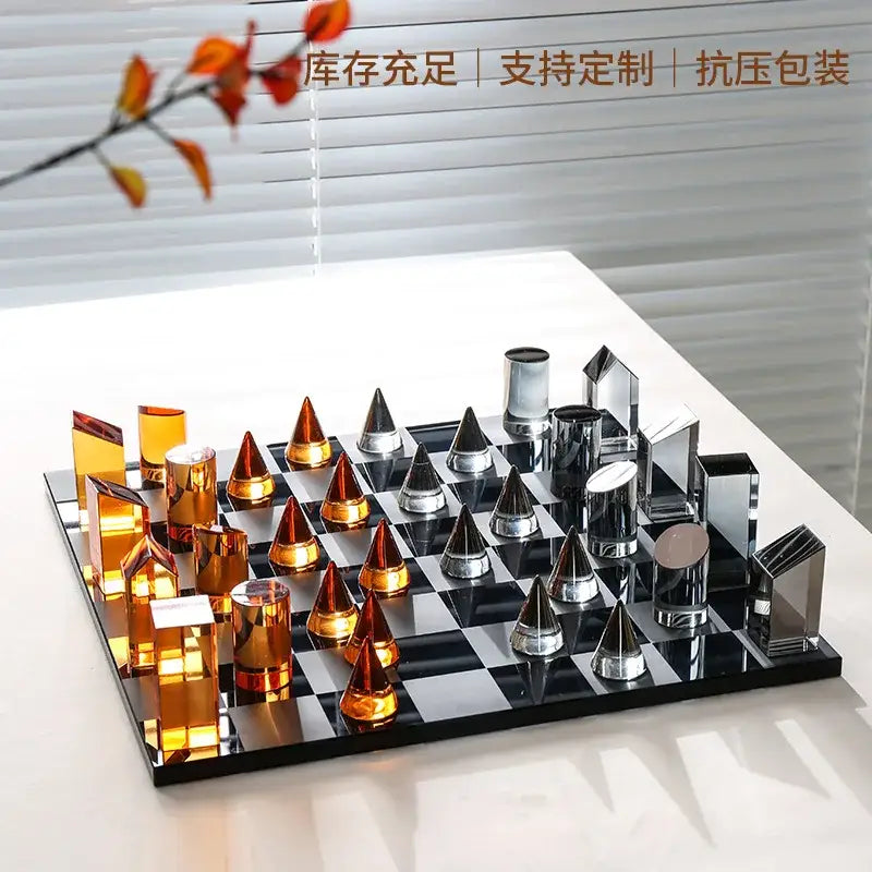 Modern glass chess set with amber and silver geometric design on mirrored board for stylish home decor use