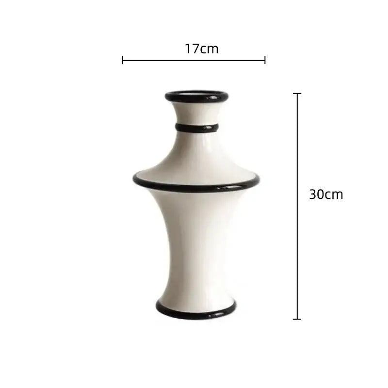 A sleek white ceramic vase with geometric black accent bands and white stripes for decorbites geometric black decor