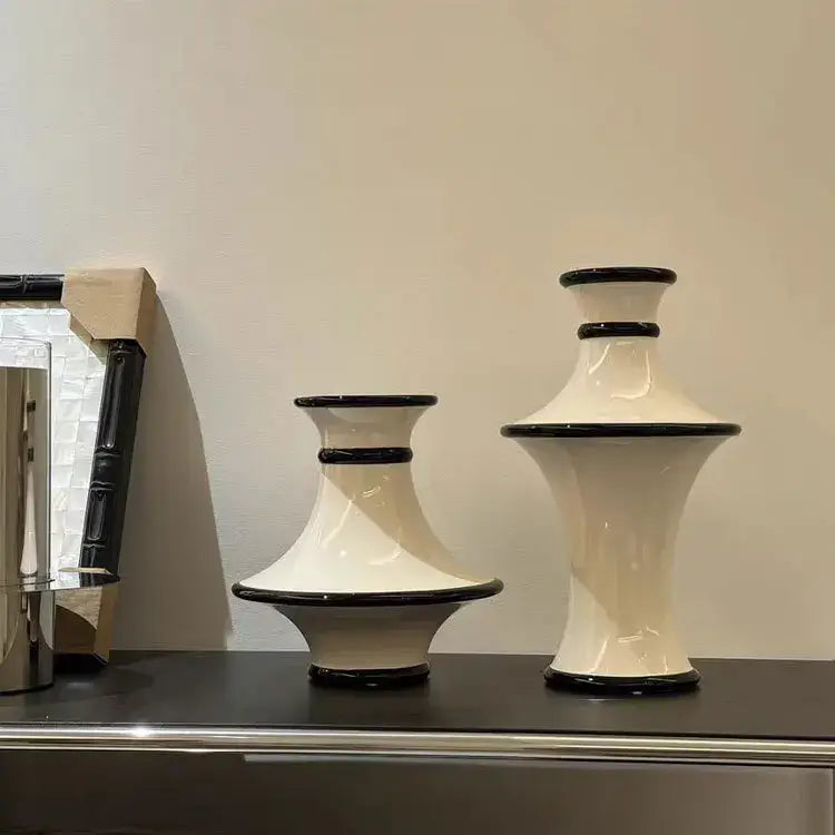 Two cream ceramic vases with sleek black rims and bases feature a modern geometric black and white stripes decorbites design