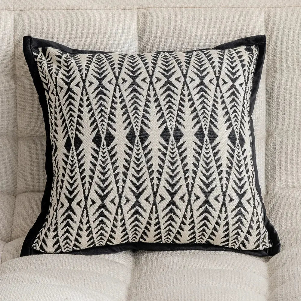 Modern geometric black and cream embroidered pillow cover with velvet trim for living room decor
