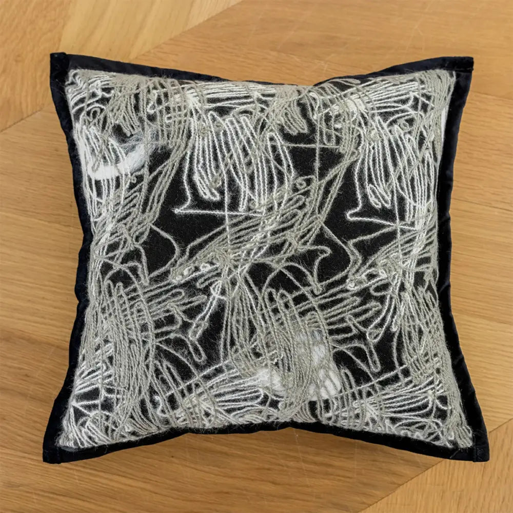 Black pillow cover with intricate silver thread embroidered abstract flowing patterns for modern living room decor