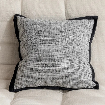Modern geometric black and white embroidered pillow cover with textured tweed fabric and black velvet trim for living room