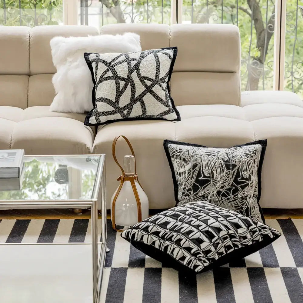 Modern geometric black and white embroidered pillow cover featuring intricate geometric patterns for living room decor