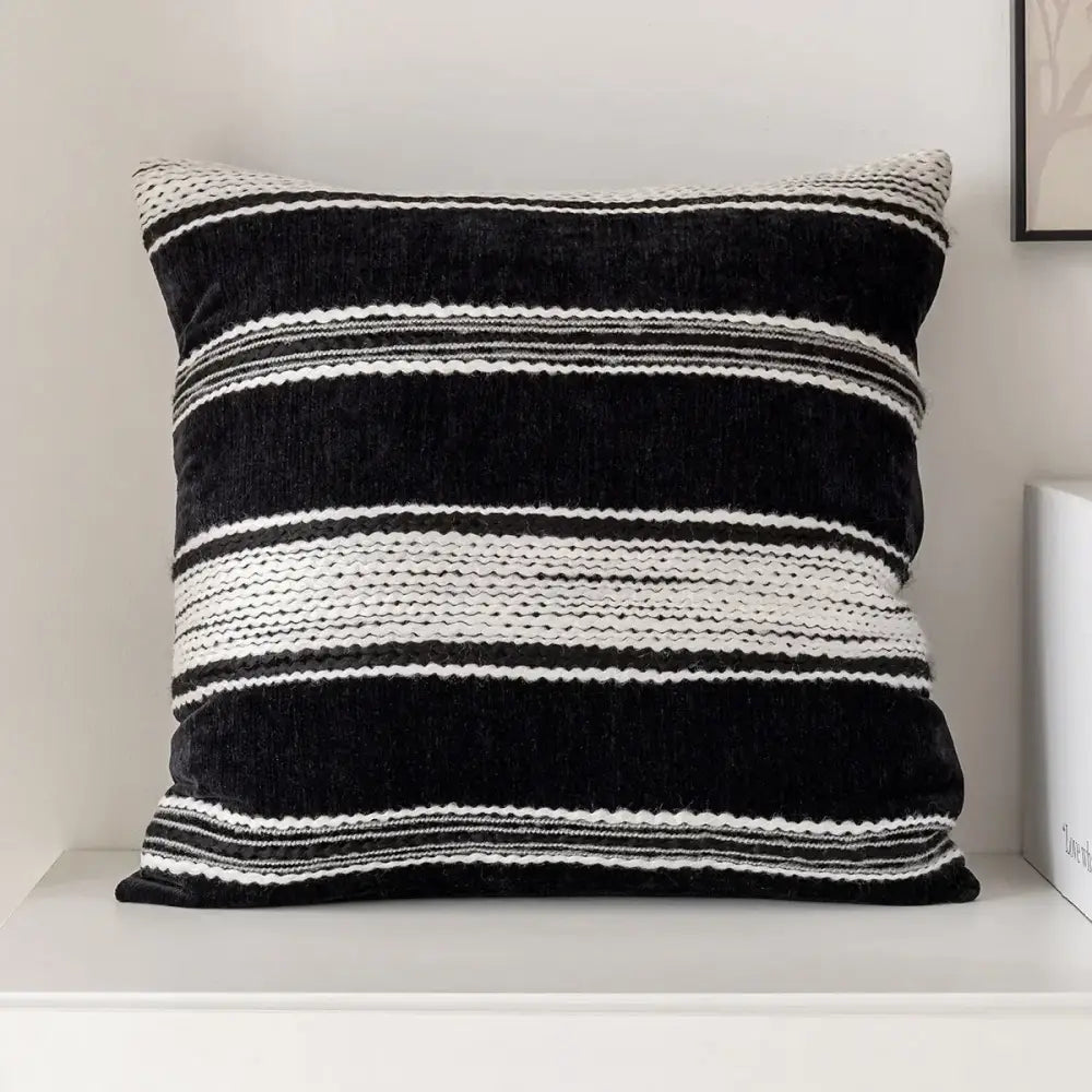 Modern geometric black and white embroidered pillow cover with velvet and textured woven accents for living room decor