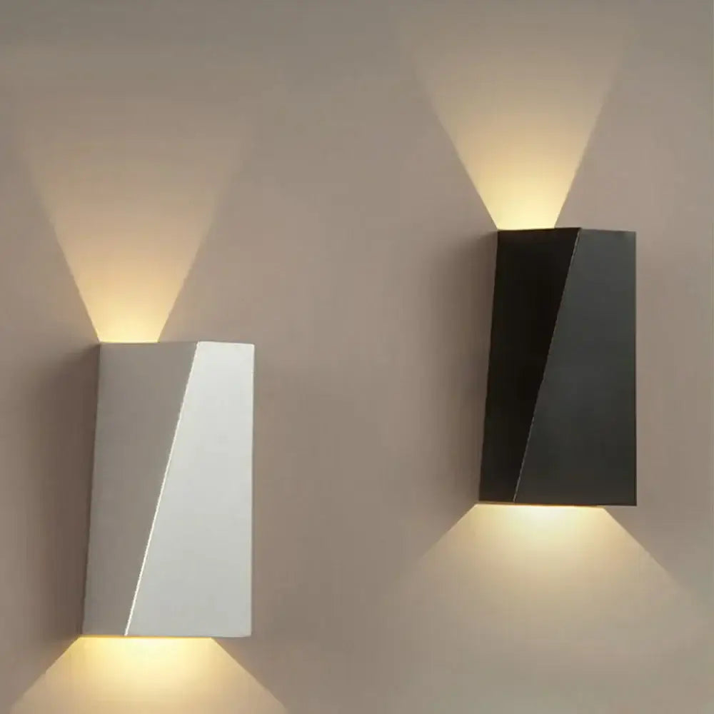 Modern geometric black and white led wall light with sharp angular design casting warm focused light for living room decorbites led wall