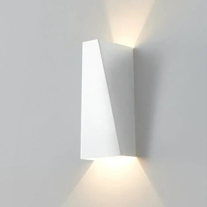 Modern geometric black and white led wall light with angular minimalist design casting warm light for living room decorbites led wall