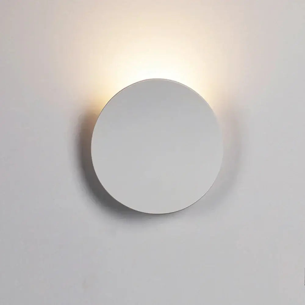Minimalist white circular led wall light emitting warm soft glow for modern geometric black and white living room decorbites led wall