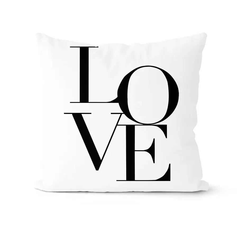 White throw pillow with bold black love lettering in modern stacked typography from decorbites geometric black white pillowcase set