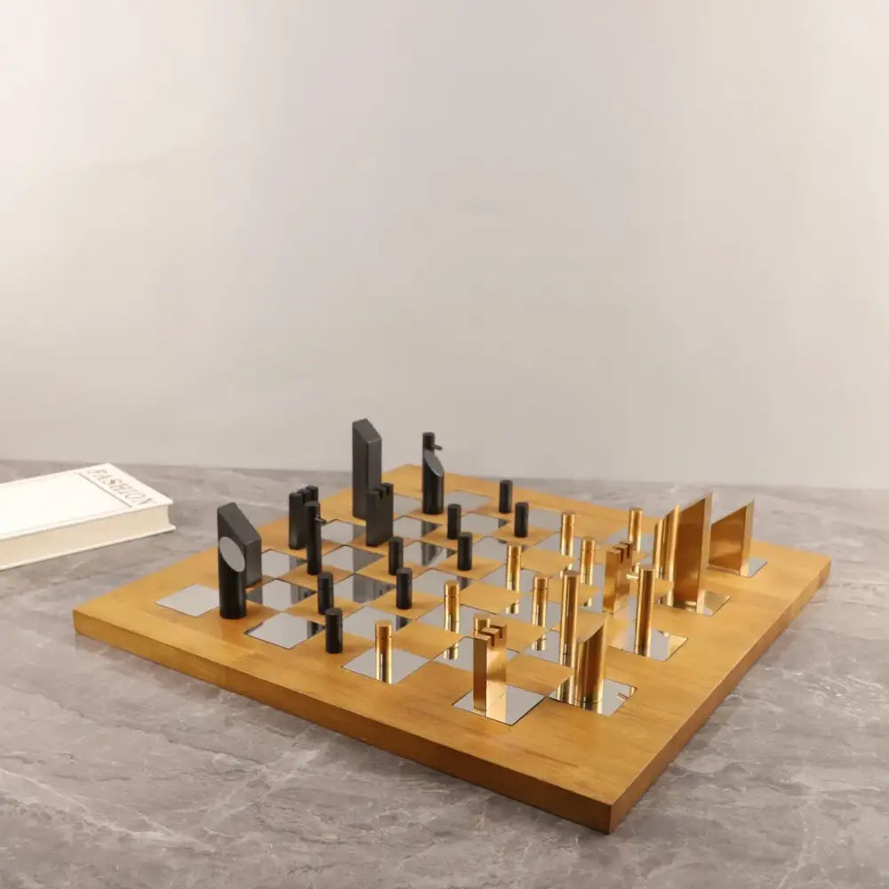 Modern geometric block chess set with a wooden board and gold and black metallic pieces for decorbites living room decor