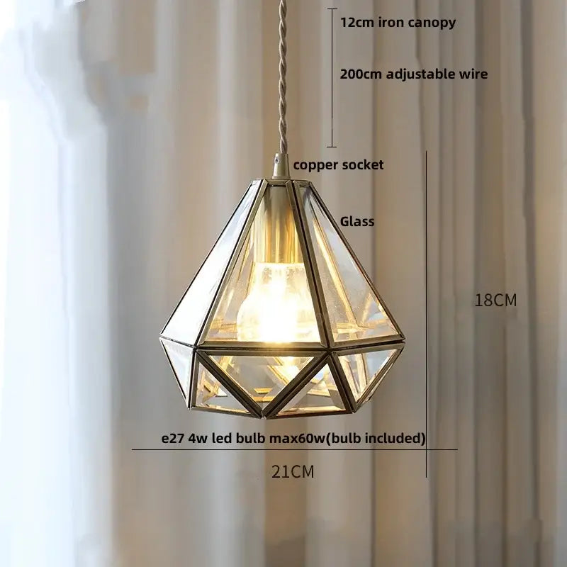 Modern geometric pendant light featuring blue glass panels and brass frame suspended by adjustable copper wire for dining room decorbites blue glass