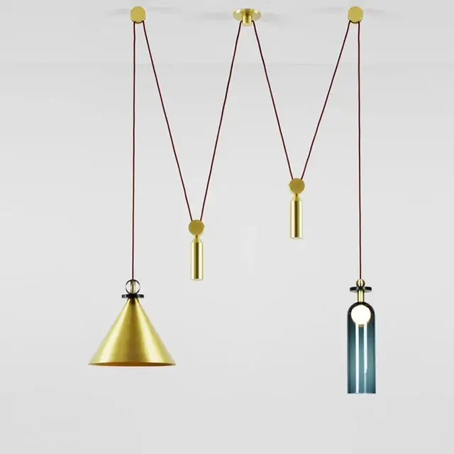 Gold-toned modern geometric pendant light with brass and black glass shades suspended by braided cords for dining room