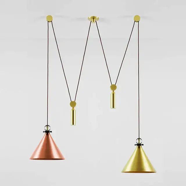 Two conical pendant lights with copper and gold finishes hang from adjustable black cords in a dining room pendant light