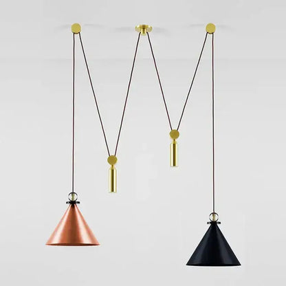 Two conical pendant lights in copper and black glass hang from adjustable brass chains for modern dining room use