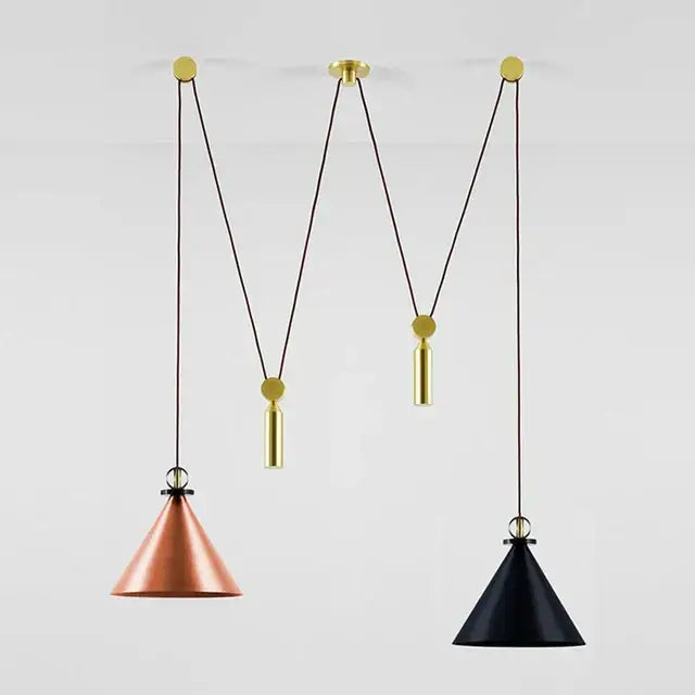 Two conical pendant lights in copper and black glass hang from adjustable brass chains for modern dining room use