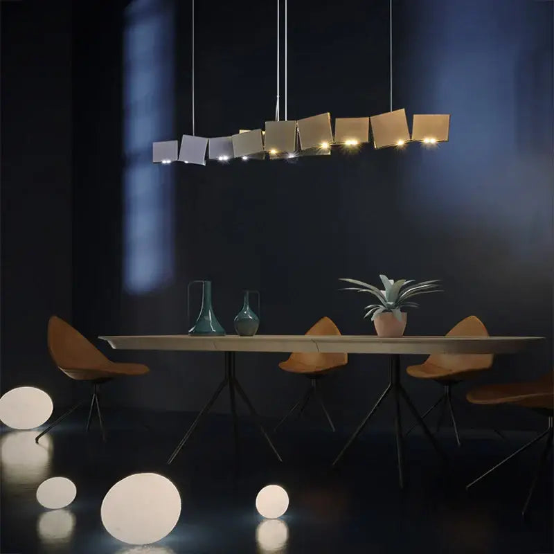 Modern geometric box shape pendant light in bronze and dark gray with matte gold and silver panels for dining room decorbites