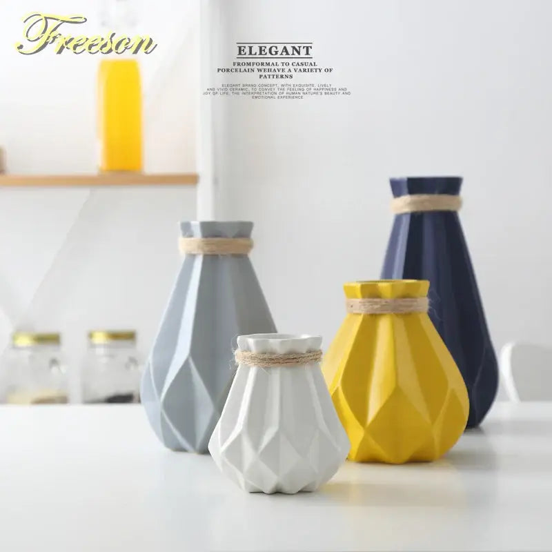 Set of four decorbites ceramic diamond vases in gray navy blue yellow and white with textured faceted surfaces and twine bands