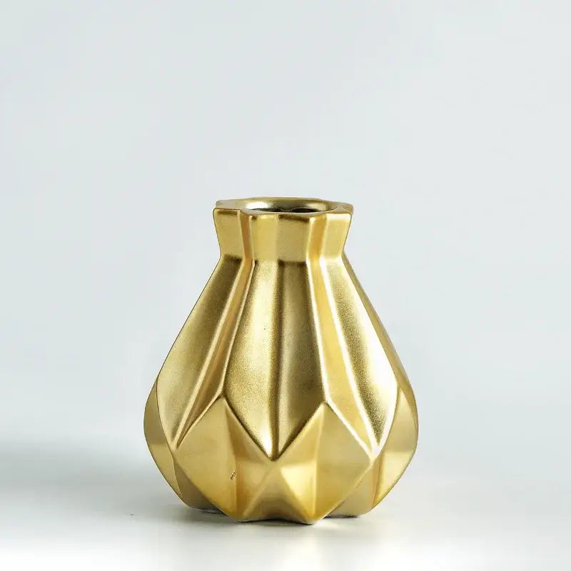 A sleek gold-finished decorbites ceramic diamond vase with geometric faceted design for modern living room decor