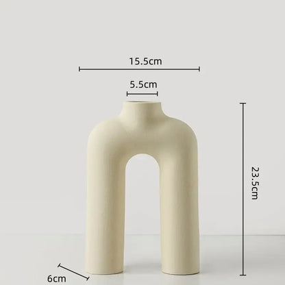 Cream-colored geometric ceramic vase with modern minimalist u-shaped design for yellow and terracotta decorbites geometric decor
