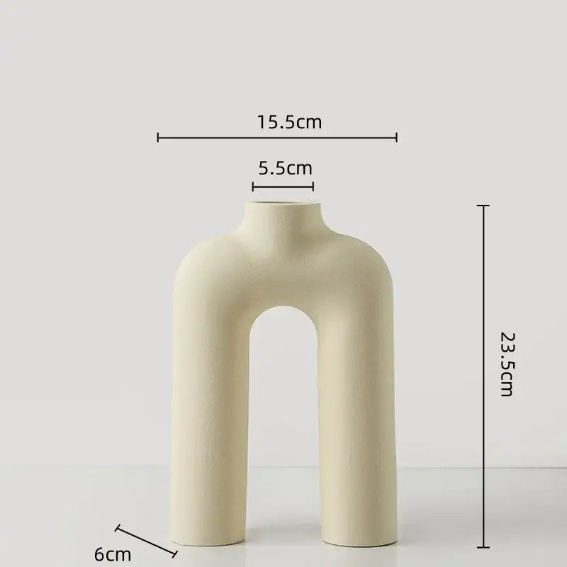 Cream-colored geometric ceramic vase with modern minimalist u-shaped design for yellow and terracotta decorbites geometric decor