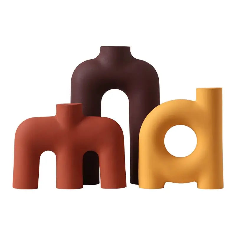 Three decorbites geometric ceramic vases in rust, deep brown, and mustard yellow with matte finish for living room decor