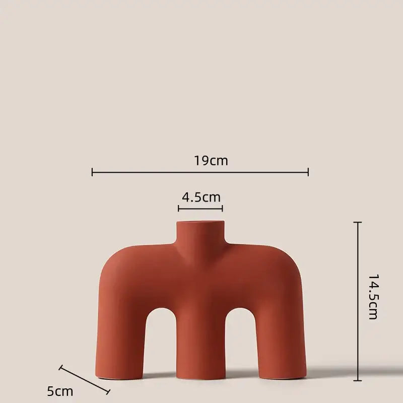 Terracotta-colored decorbites geometric ceramic vase with three arched openings and smooth rounded contours for living room decor