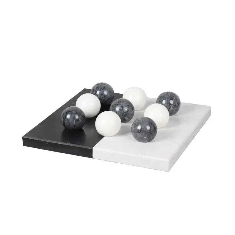 Modern geometric chess ornament set with black and white marble checkers and glossy spherical pieces for home decor