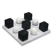 Modern geometric chess ornament set with black and white glossy cubes and spheres on gray grid base for home decor