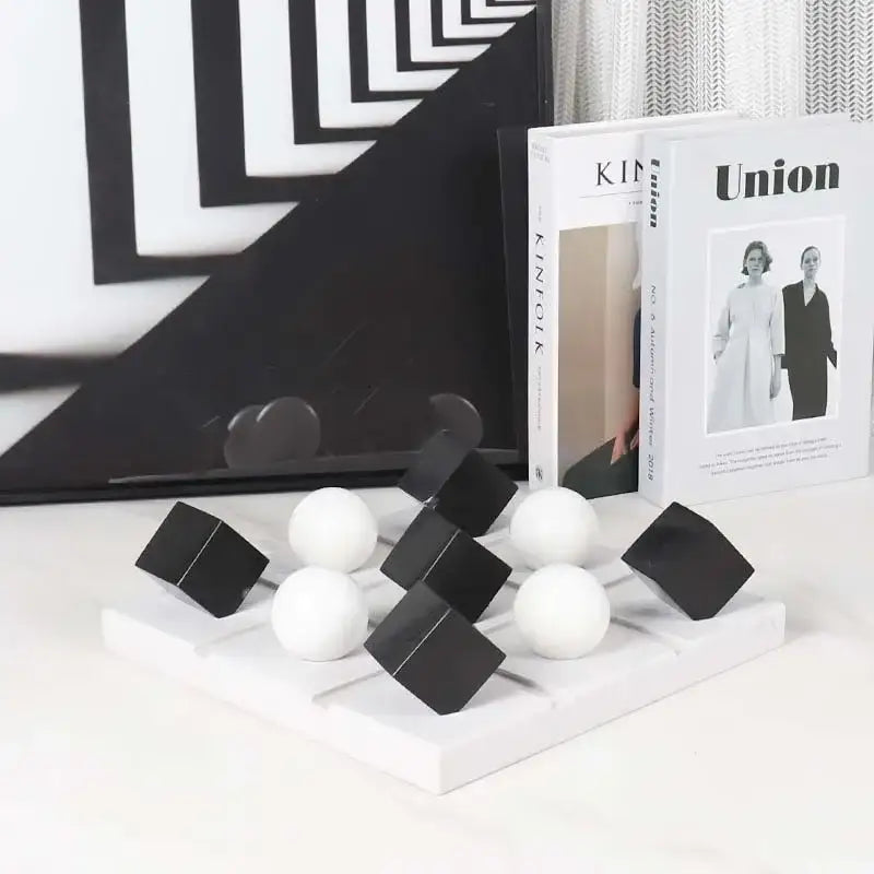 Modern geometric chess ornament set in black and white on a minimalist white base for stylish home decor
