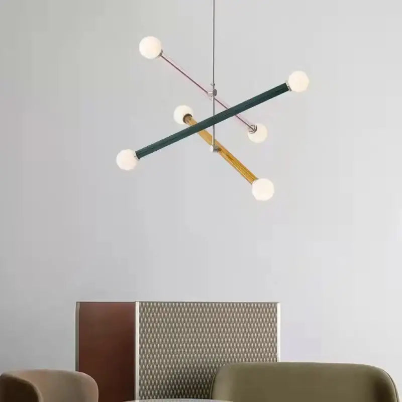 Modern geometric colorful chandelier art deco with intersecting matte green, wood, and rose gold rods with frosted globes