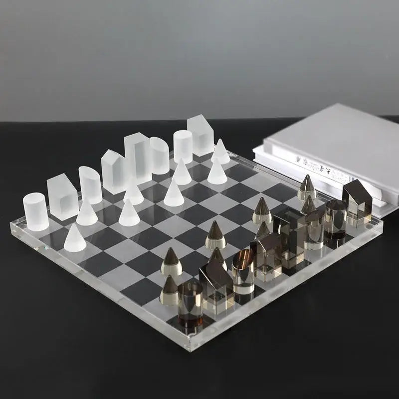 Modern geometric crystal chess set with translucent white and metallic pieces on clear board for living room decorbites decor