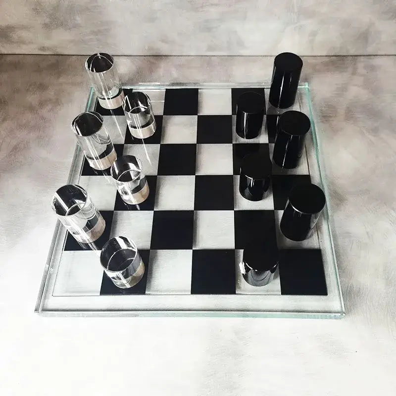 Modern geometric crystal chess set with transparent checkered board and sleek black and silver cylindrical pieces for decorbites decor